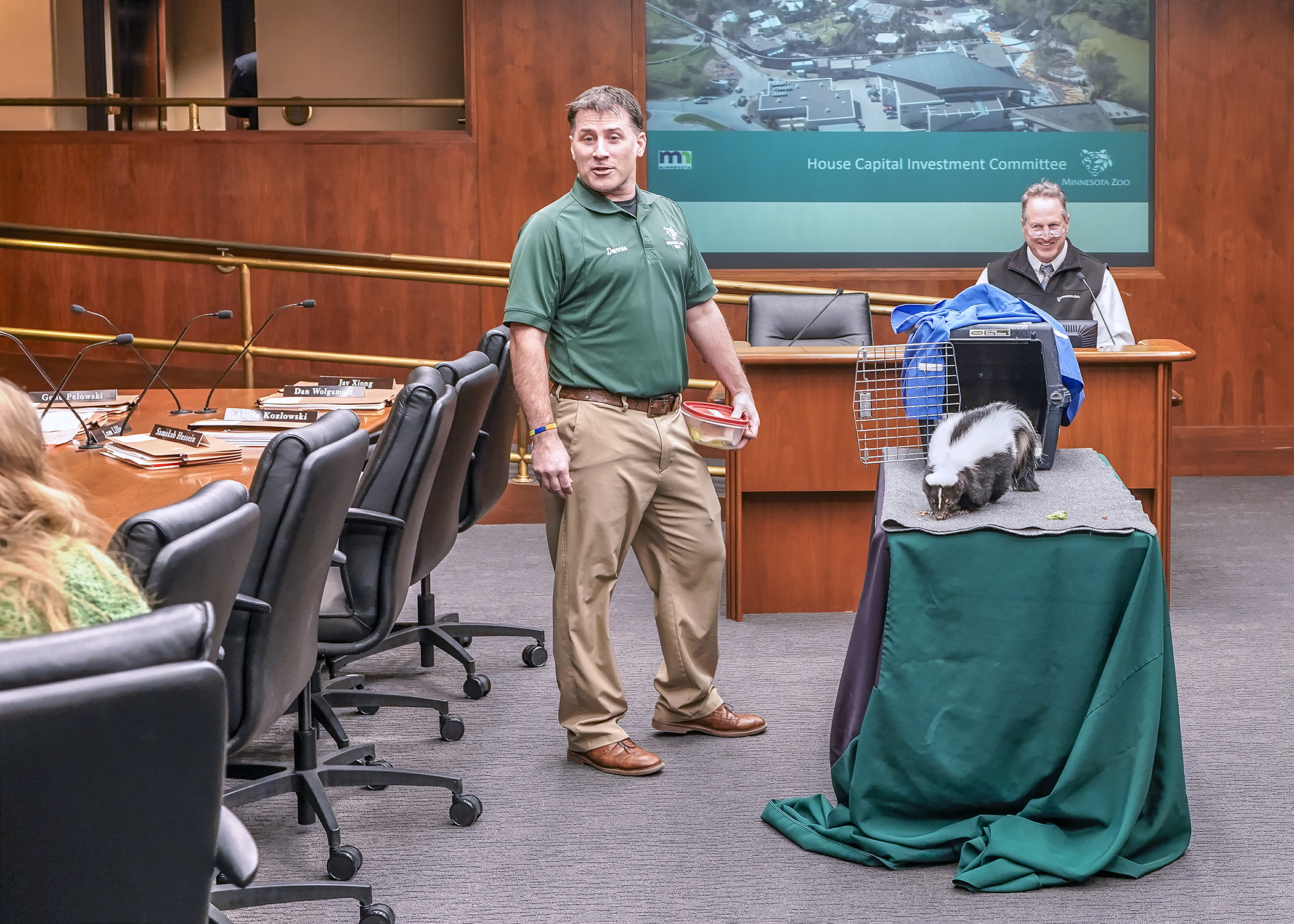 Donnie Crook, a Minnesota Zoo naturalist, and Director John Frawley introduce Leia, a 9-year-old striped skunk, to the House Capital Investment Committee March 18. (Photo by Andrew VonBank)